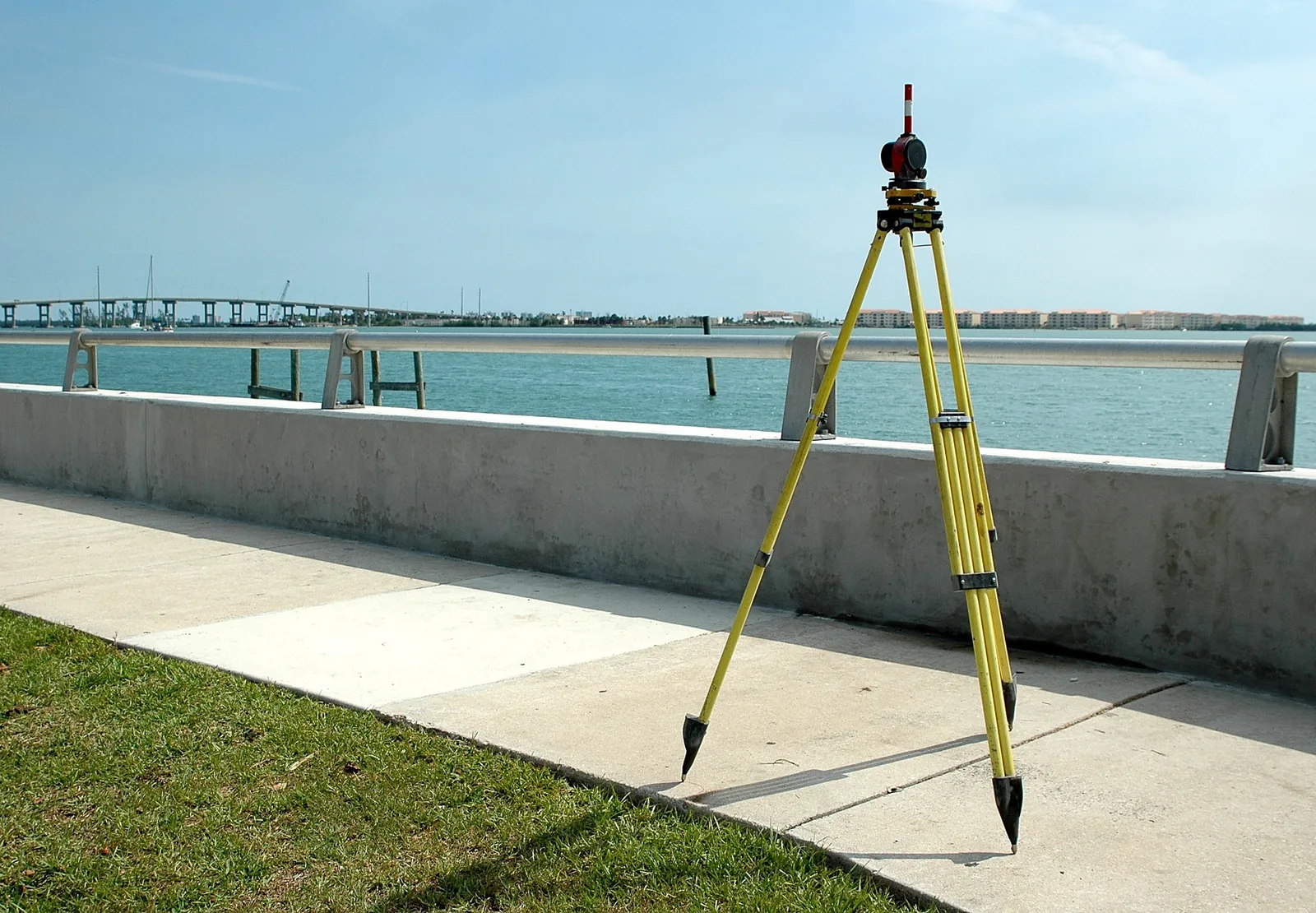 Survey equipment set up for floodplain and elevation documentation near the water